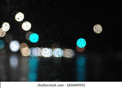 Vague City Lights Through The Window With Raindrops