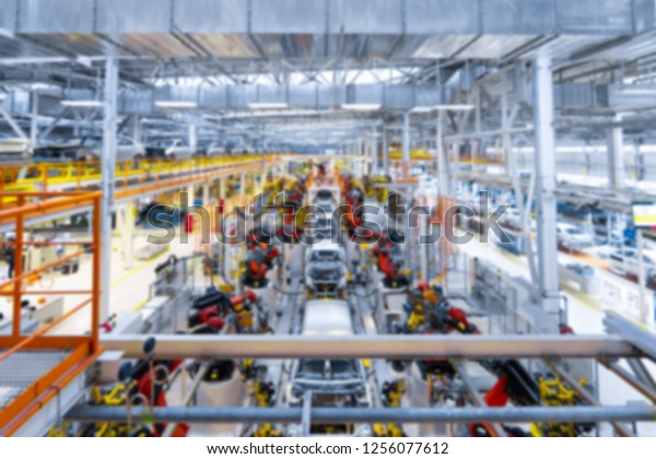 vague premise of Assembly line production of\
cars. Defocused image of car\
factory
