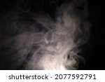 vague puffs of smoke on a black background. High quality photo
