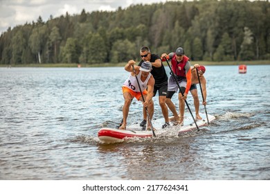 Vaidava, Latvia - 01.08.2021: A Lot Of People Paddle With SUP Stand Up Paddle Board. SUP Competition, Race. Awesome Active Outdoor Recreation.