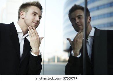 Vain Business Man Checking His Looks In The Mirror