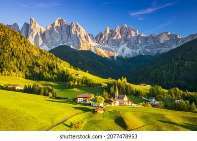 Val di Funes, Italy - Beautiful St. Magdalena village with magical Dolomites mountains in a gorgeous Funes valley, South Tyrol, Italian Alps at autumn sunset.