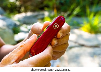 Val Gardena, Italy - October 25 2022: Victorinox Swiss Army Knife, A Man With His Multi-tool Knife In The Woods Of The Dolomites, South Tyrol, Italy.