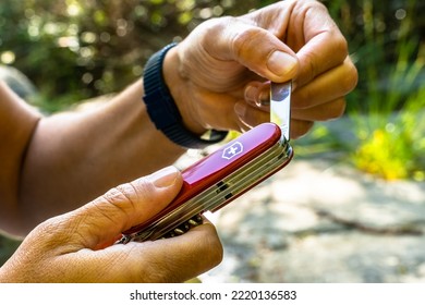 Val Gardena, Italy - October 25 2022: Victorinox Swiss Army Knife, A Man With His Multi-tool Knife In The Woods Of The Dolomites, South Tyrol, Italy.