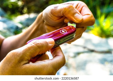 Val Gardena, Italy - October 25 2022: Victorinox Swiss Army Knife, A Man With His Multi-tool Knife In The Woods Of The Dolomites, South Tyrol, Italy.