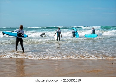 VALE FIGUEIRAS, PORTUGAL - March 29, 2022: Surfers getting surfers lessons at the atlantic ocean in Portugal