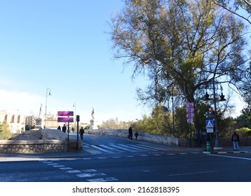 Valencia city street, road traffic, cars on road, people and buildings. Urban architecture, square, trees in parks and panarama.  Possible granularity, motion blur. Dec 15, 2021, Spain, Valencia.
