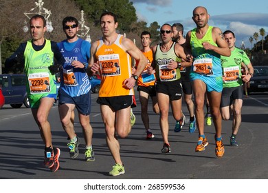 VALENCIA, SPAIN - FEBRUARY 22, 2015: Runners compete in the IV University of Valencia 5K run in the streets of Valencia.