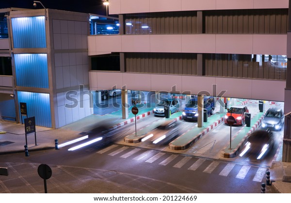 VALENCIA, SPAIN - JUNE 25, 2014: Cars exiting\
the parking garage at the Valencia airport. Situated 8 km from the\
city it is the 8th busiest Spanish airport with flight connections\
to 15 countries.