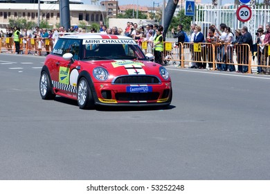VALENCIA, SPAIN - MAY 16: To promote the Mini Challenge 2010 event, a Mini Cooper gives a demo in the streets of Valencia with the female driver Marta Suria on May 16, 2010 in Valencia, Spain.