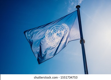 Valencia, Spain - November 2, 2019: UN Flag Waved Against The Sun And Blue Sky.