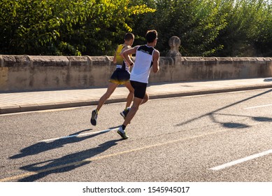 Valencia, Spain - October 27, 2019: Participant In A Half Marathon Race Running On The Asphalt Of The City Of Valencia.