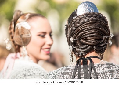 VALENCIA, SPAIN - OCTOBER 28, 2020: Two Falleras Talking. Detail Of The Hairstyle Typical In This Valencian Celebration. Hair Bun Seen From Behind.