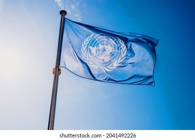Valencia, Spain - September 8, 2021: UN flag waved against the sun and blue sky.