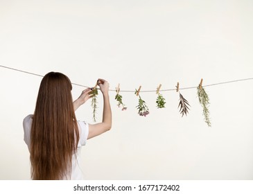 Valencia,Spain, 5,6,2015: Woman Hanging Plants With Clothespins