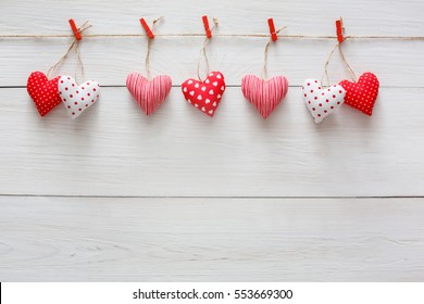 Valentine Background With Sewed Pillow Diy Handmade Hearts Row Border On Red Clothespins At Rustic White Wood Planks. Happy Lovers Day Card Mockup, Copy Space