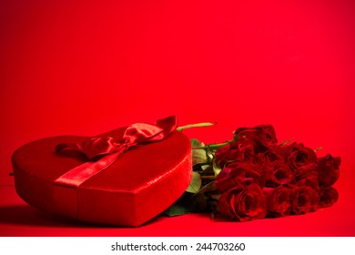 A Valentine Candy Box And Red Roses On Red Background