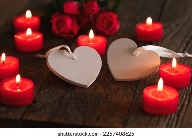 Valentine card motive, valentines greetings, wedding concept _ red candlellights with white heart on wooden dark underground - Shutterstock ID 2257408625
