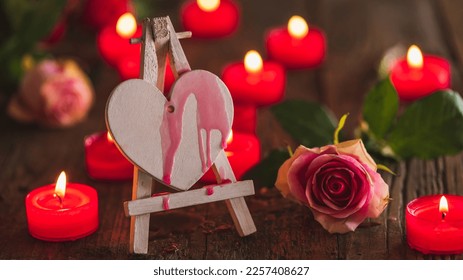 Valentine card motive, valentines greetings, wedding concept _ red candlellights with white heart on wooden dark underground - Shutterstock ID 2257408627