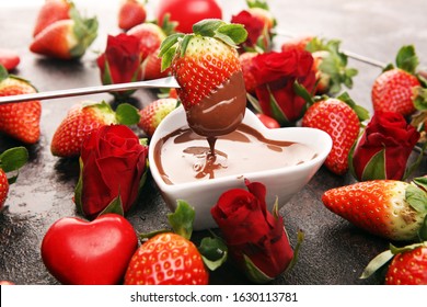 Valentine Chocolate Fondue Melted With Fresh Strawberries And Dark Chocolate. Red Roses And Sugar Hearts For Valentines Day. Dessert For Love
