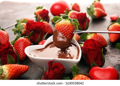 Valentine Chocolate Fondue Melted With Fresh Strawberries And Dark Chocolate. Red Roses And Sugar Hearts For Valentines Day. Dessert For Love