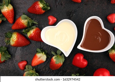 Valentine Chocolate Fondue Melted With Fresh Strawberries And Dark And White Chocolate. Red Roses And Sugar Hearts For Valentines Day. Dessert For Love