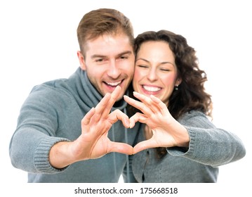 Valentine Couple Isolated On White Background. Portrait Of Smiling Beauty Girl And Her Handsome Boyfriend Making Shape Of Heart By Their Hands. Happy Joyful Family. Heart Sign. Valentines Day 