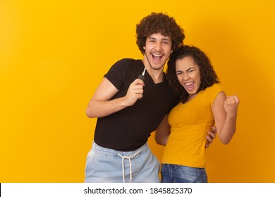 valentine couple on yellow background holding house key. New home concept