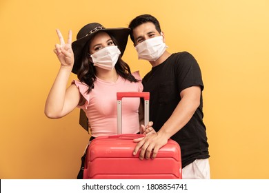 Valentine couple with travel bag and protective mask. New normal