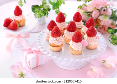 Valentine cupcakes with white chocolate and strawberry cream with strawberry. 
Valentine bouquet of rose flowers  and gift.