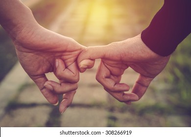 Valentine day background. Happy couple holding hands together as forever love. Vintage filter. - Shutterstock ID 308266919