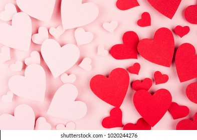 Valentine day background. Stream of fly paper red and pink hearts on pink color backdrop.