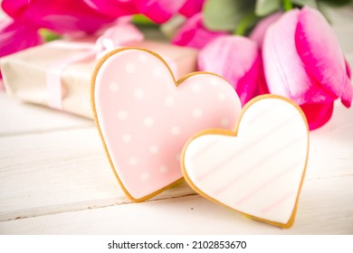 Valentine Day Concept, Spring Woman Day Holiday, Mothers Day Background, Red Tulip Flowers Bouquet, Craft Paper Gift Box, Heart Shaped Traditional Sugar Cookies, White Wooden Background Copy Space