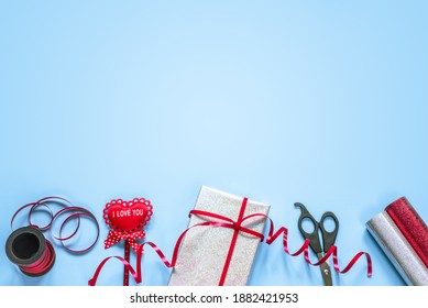 Valentine Day Gift Wrapping Supplies On Blue Background With Copy Space