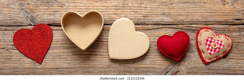 Valentine Day Love Symbol Three Red Fabric Heart And One Open Empty Gift Box On Wooden Background. Overhead View. Banner.