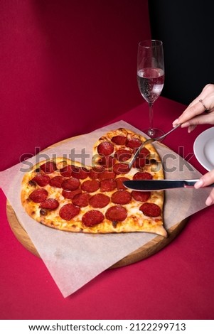 Valentine Day pizza or restaurant concept. love shape pizza isolated on red background concept of valentine day. 