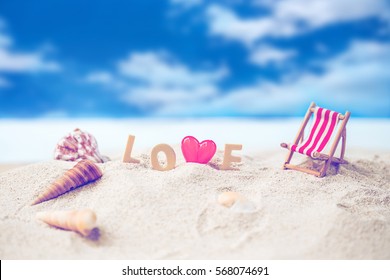 valentine decoration with love wooden text and beach chair on white sand beach with tropical blue sea and clear blue sky,Image For Love Valentine Day or summer vacation Concept,vintage tone.