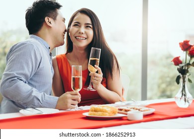 Valentine Festive Date At Restaurant Concept. Smile Adult Asian Lover Couple Man And Woman Hand Hold A Champagne Drink. Romantic Dinner At Restaurant