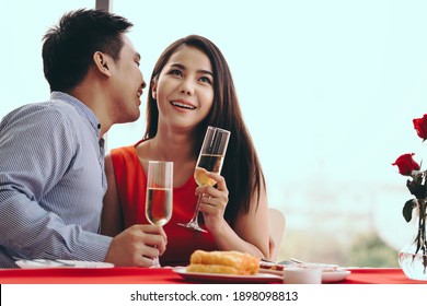 Valentine Festive Date At Restaurant Concept. Smile Adult Asian Lover Couple Man And Woman Hand Hold A Champagne Drink. Romantic Dinner At Restaurant