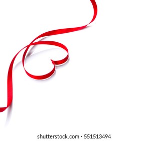 Valentine Heart. Elegant Red heart shaped satin gift Ribbon Isolated on white. Valentine's Day Border design. Red silk ribbon curves Valentines Frame.