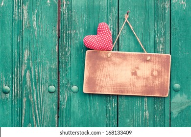 Valentine heart and sign board on wooden vintage background