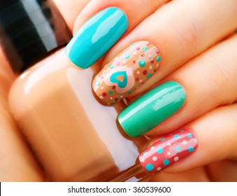 Valentine Nail art manicure. Valentines Day Holiday style bright Manicure with painted hearts and polka dots. Bottle of Nail Polish. Beauty salon. Hand. Trendy Stylish Colorful Nails, Nailpolish