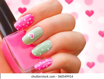 Valentine Nail Art Manicure. Valentine's Day Holiday Style Bright Manicure With Painted Hearts And Polka Dots. Bottle Of Nail Polish. Beauty Salon. Hand. Trendy Stylish Colorful Nails, Nailpolish