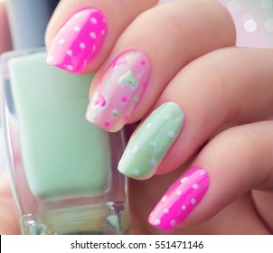 Valentine Nail Art Manicure. Valentine's Day Holiday Style Bright Manicure With Painted Hearts And Polka Dots. Bottle Of Nail Polish. Beauty Salon. Hand. Trendy Stylish Colorful Nails, Nailpolish.