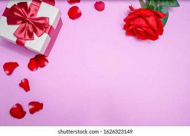 valentine pink pastel background with red gift box and beautiful rose, petal of rose  - Shutterstock ID 1626323149