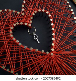 Valentine String Art. Valentine's Day String Art Red Heart Framed. Valentine's Day Gift Of A Painting In The Style Of String Art. Hobby. Key From The Heart. Heart Of Red Threads. Weaving Close Up