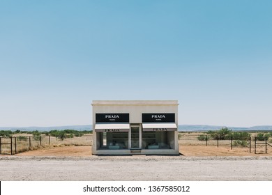 Valentine, Texas USA June 16 2017 Prada Marfa Art Installation Sits On Display In The Middle Of Nowhere With Bright Blue Sky Above