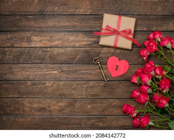 Valentines background with heart key gift box and flowers on wooden background with copy-space. Key of my heart concept.