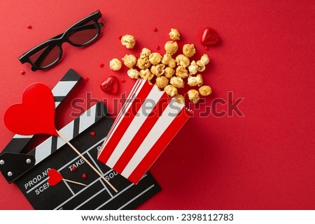 Valentine's Cinema Affair: top view of clapperboard, 3D glasses, popcorn cascading from box, sweet chocolate treats, heart-shaped ornaments on red— cinematic celebration for premiere of romantic film