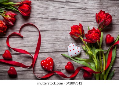 Valentines Day background with chocolates, hearts and red tulips - Shutterstock ID 342897512